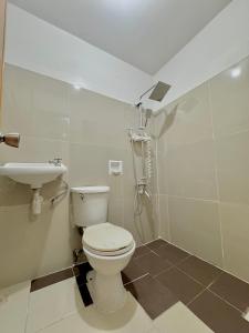 a bathroom with a toilet and a sink at ACE Condo in Cebu City +5 photos