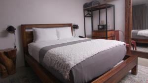 Ένα ή περισσότερα κρεβάτια σε δωμάτιο στο L86 Hotel Boutique y Eventos
