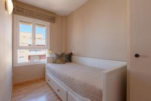 a bedroom with a bed and a window at Marbella Port Beachfront - EaW Homes in Marbella