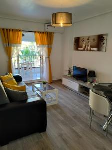 a living room with a couch and a tv at Eldorado Apartment La Mata in La Mata +82 photos