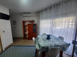 a dining room with a table and chairs and a window at Eucalytus I in Salou