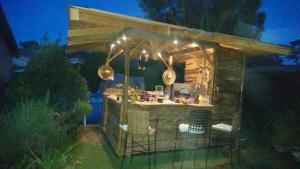 an outdoor kitchen with lights at night at Villa beldi in Lacanau +31 photos
