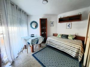 a bedroom with a bed and a table in it at Eucalytus I in Salou