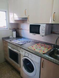 a kitchen with a washing machine and a sink at Eucalytus I in Salou +26 photos