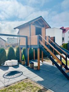 a house with a staircase in front of it at Karwia Marina Apartamenty in Karwia