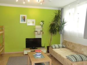 a living room with a couch and a tv at Ferienwohnung Koch in Rust