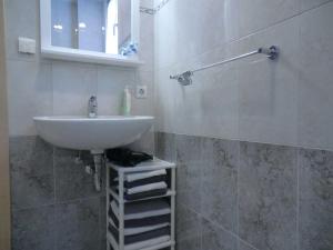 a bathroom with a white sink and a mirror at Ferienwohnung Koch in Rust +9 photos