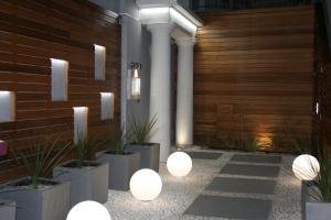 a courtyard with a row of lights and potted plants at Les Embruns in Trouville-sur-Mer