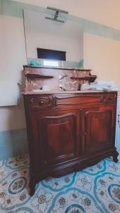 a wooden dresser in a bathroom with a mirror at Paomà Sorrento in Agropoli +53 photos