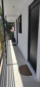 a door to a building with a sidewalk and a gate at Hospedaje 'Los Ángeles ' in Huasca de Ocampo