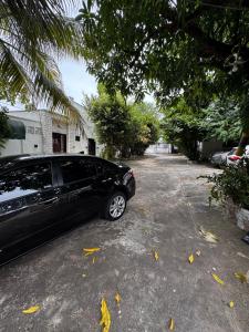 a black car parked in a parking lot at Casa do Marcus in Barra do Garças