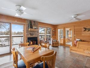 a dining room with a table and a fireplace at Eagles Rest on Whitefish Chain in Pine River +19 photos