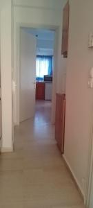 an empty room with a kitchen and a hallway at neptune resort apartments in Kavos +23 photos