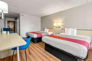a hotel room with two beds and a table at Motel 6-Decatur, GA in Decatur +42 photos