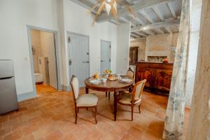 a kitchen and dining room with a table and chairs at La Chambre Bleue in Lauzerte +11 photos