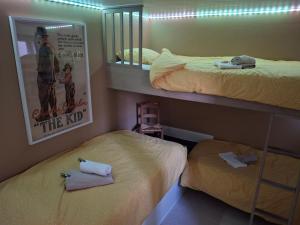 a bedroom with two bunk beds and a mirror at Het Koetshuis, op 50m van zee, voor 5 personen, centrum Westende BAD, alle comfort in Middelkerke