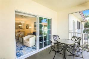 a room with a balcony with a table and chairs at Bellasera Resort in Naples