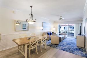 a dining room and living room with a table and chairs at Bellasera Resort in Naples