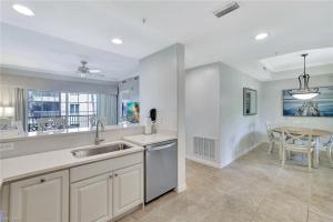 a kitchen with a sink and a table at Bellasera Resort in Naples