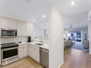 a white kitchen with a sink and a stove at Bellasera Resort in Naples