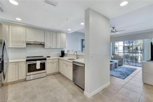 a large kitchen with white cabinets and appliances at Bellasera Resort in Naples