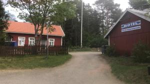 a red barn with a sign on the side of it at Majatalo Eura in Eura