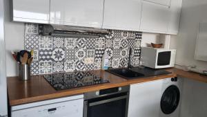 a kitchen with a counter top with a microwave at Costa Plana apartment with terrace and sea view in Cap d'Ail