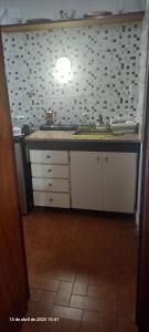 a kitchen with a sink and a counter top at VICTORIA 2 bed and breakfast departamento in Ezeiza