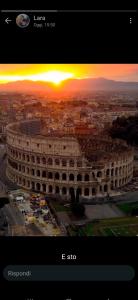 a view of a large building with a sunset in the background at Incantevole con Jacuzzi in Rome