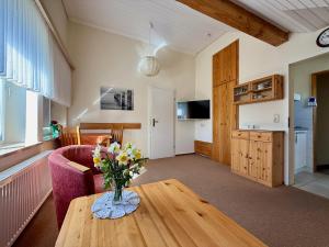 a living room with a vase of flowers on a table at Sandnah in Fehmarn