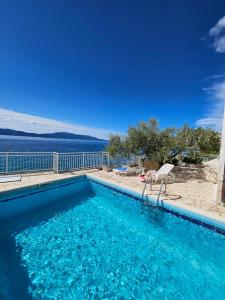 a swimming pool with a view of the water at Villa Falcon in Podaca