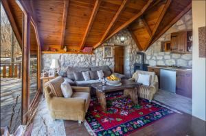 a living room with a couch and a table at Montenegro Rustic House II in Bjeloši