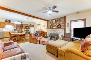 a living room with a couch and a tv at Historic Farmhouse on 7 Acres with Stellar View! in Kearney