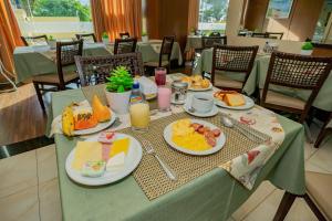 a table with plates of breakfast food on it at Paradise Flat in Natal