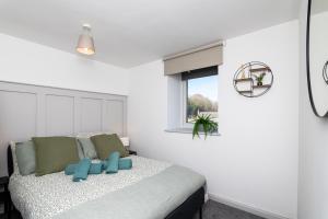 a bedroom with a bed with a blue teddy bear on it at 5 Bedroom Apartment - Galashiels in Galashiels