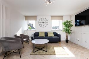 a living room with a couch and a table at 5 Bedroom Apartment - Galashiels in Galashiels