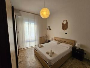 a bedroom with a bed with two towels on it at Ele's apartment in La Spezia