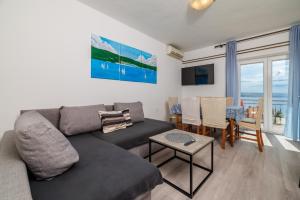 a living room with a couch and a table at Apartment Tus A1 in Crikvenica