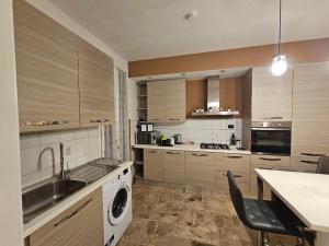 a kitchen with a sink and a washing machine at Ele's apartment in La Spezia