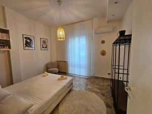 a small bedroom with a bed and a chandelier at Ele's apartment in La Spezia +3 photos