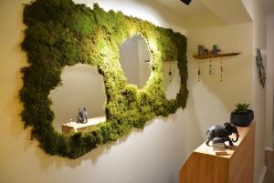a mirror covered in green ivy on a wall at Gaja Ayvalık in Ayvalık +56 photos