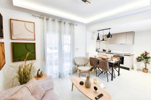 a living room with a couch and a table at Comfy Dots 2 in Larisa +17 photos
