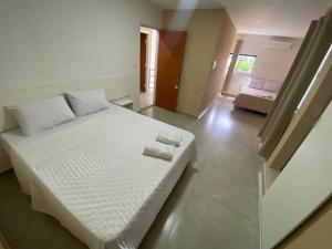 Voodi või voodid majutusasutuse Hotel Sur Brasil toas