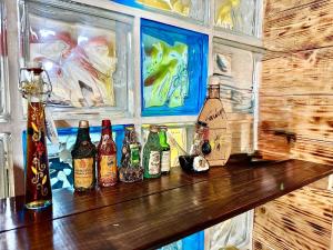 a group of bottles sitting on a wooden bar at Villa Sant Anna in Alghero