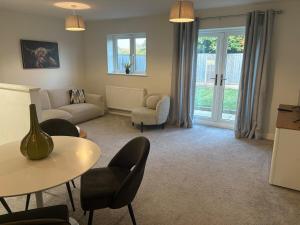 a living room with a couch and a table and chairs at Secluded Coventry Escape in Wyken