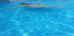 a woman is swimming in a swimming pool at GOLD RIVER in Krupa na Vrbasu