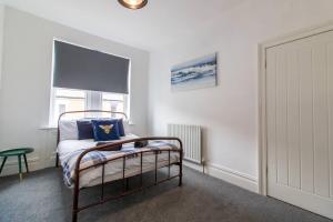 a bedroom with a bed and a window at Coastal Comfort Haven 3BR Retreat in South Shields