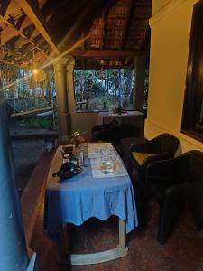 a table in a restaurant with a blue table cloth at Perch Next door in Kannur +28 photos