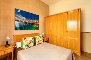 a bedroom with a bed and a wooden cabinet at SALINETAS BLUE SURF HOUSE in Telde