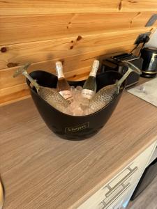 two bottles of champagne in a bucket on a counter at Killee Luxury pod and private hot tub in Coa +10 photos